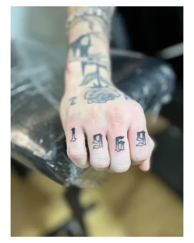 Gray Finger Tattoo Design