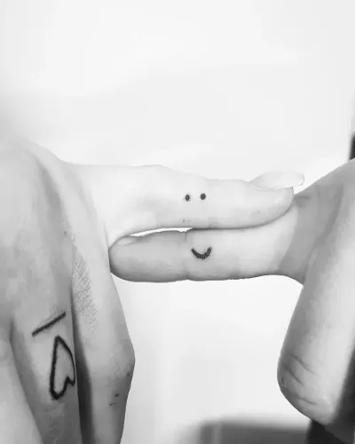 Smile-A-While Tattoo On Fingers