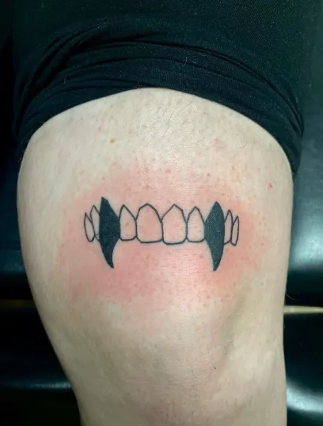 Fangs Above The Knee Tattoo